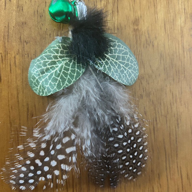 Christmas Cat Gift featuring feathered toy attachment with green bell and decorative accents.