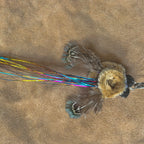 Tinsel Bum Christmas Cat Gift featuring glittery wings and colorful trailing feathers for feline playtime.