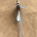 Handcrafted Silver Wisp attachment for Christmas Cat Gift, featuring shimmering feathers and intricate design.
