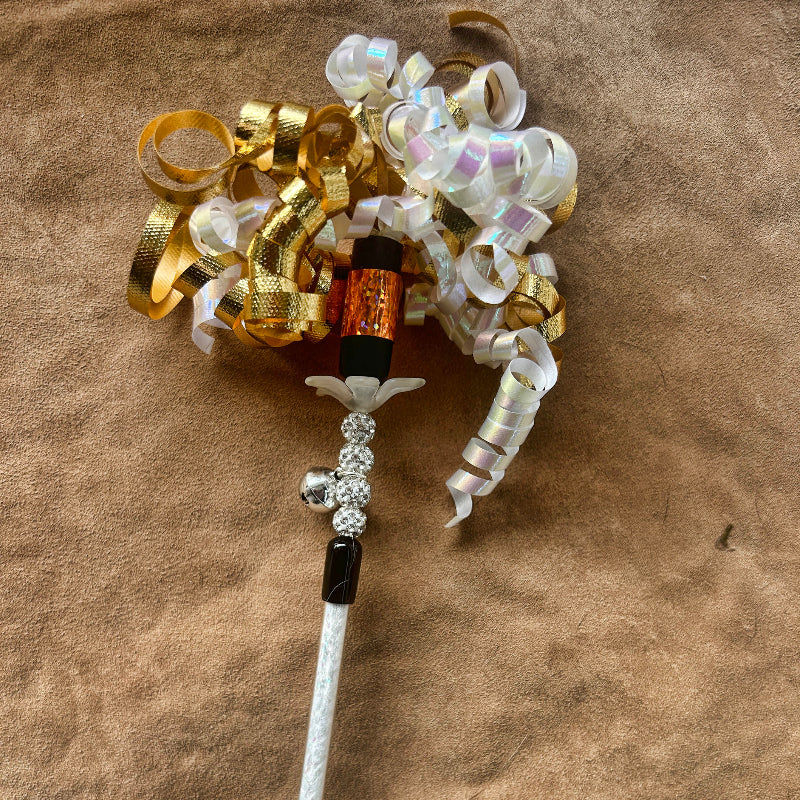Jingle Wand, a handmade Christmas cat gift, features curling ribbons and sparkling accents for festive feline fun.