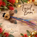Tinsel Bum Christmas Cat Gift with glittery tail and feather wings, perfect for curious cats.